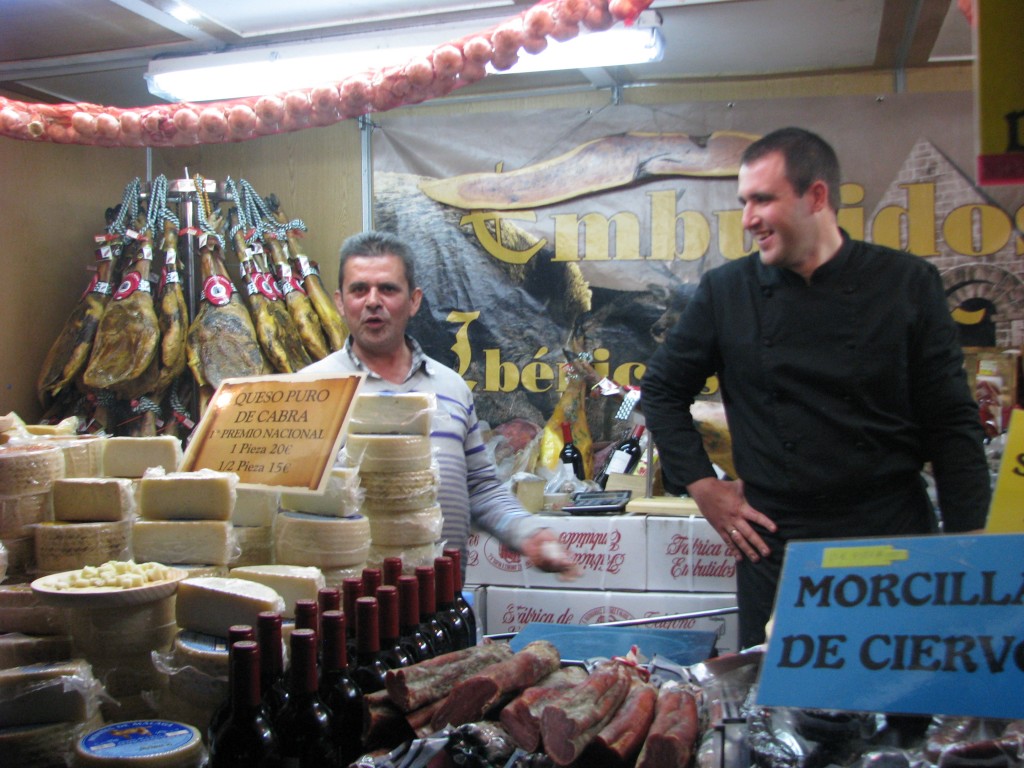 Stall selling morcilla (blood sausage), queso de cabra (goat cheese), and jamon Serrano (Iberian ham)